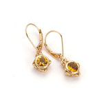 Handmade delicate gold earring with faceted citrine stones in center 