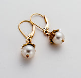Handmade pearl drop earring with delicate filigree cap over the top of the pearl