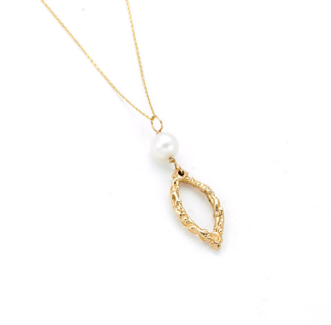 Delicate gold chain, hand carved almond shaped gold pendant with open center, white pearl accent