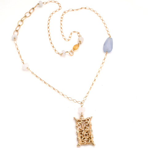Gold filigree handmade rectangular pendant on long gold chain interspersed with semi-precious stones 