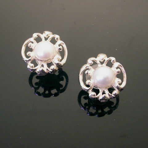 Sterling post earring, hand-carved swirls of delicate silver with open space, surrounding creamy white pearl